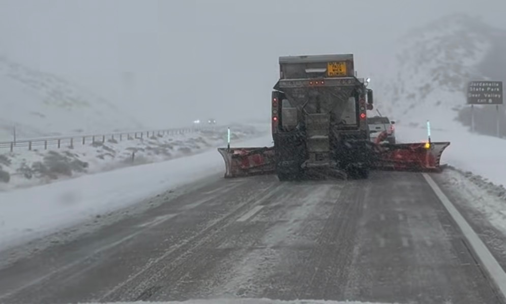 Snow plow in the middle of two lanes